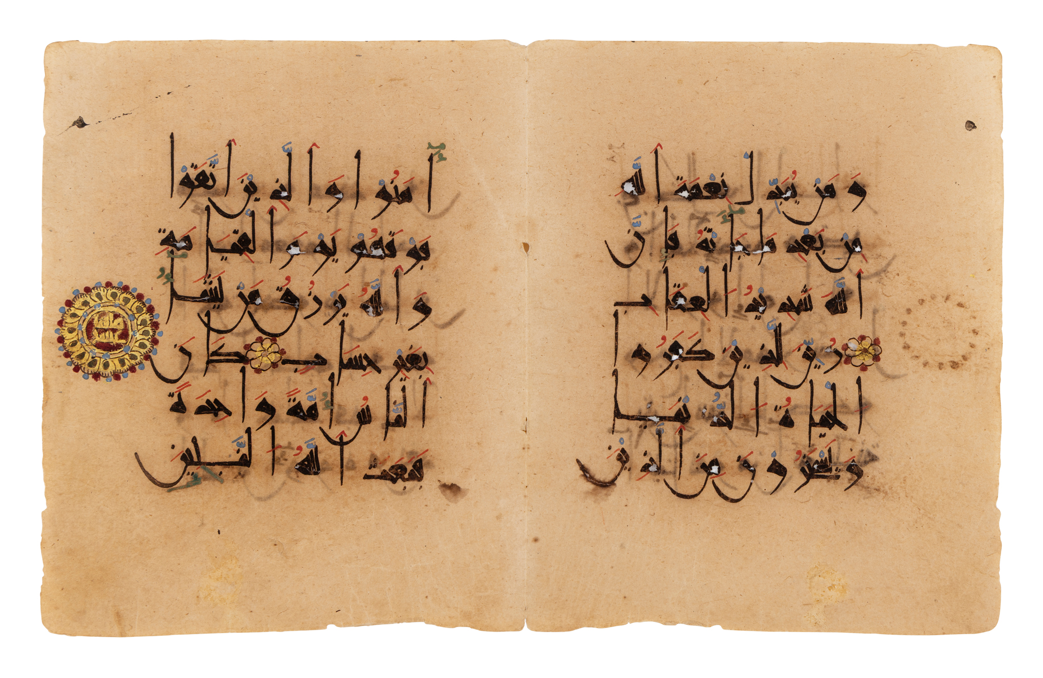 A FINE ILLUMINATED PINK KUFIC QUR'AN BIFOLIUM