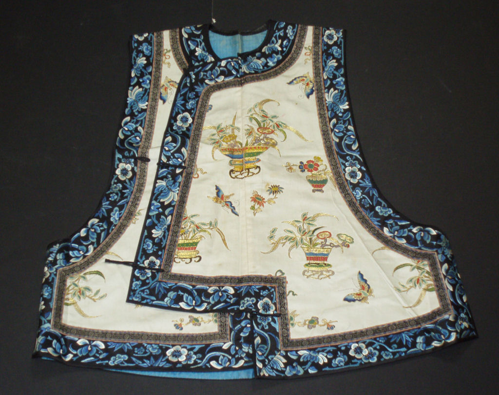 A Chinese embroidered silk waistcoat and skirt