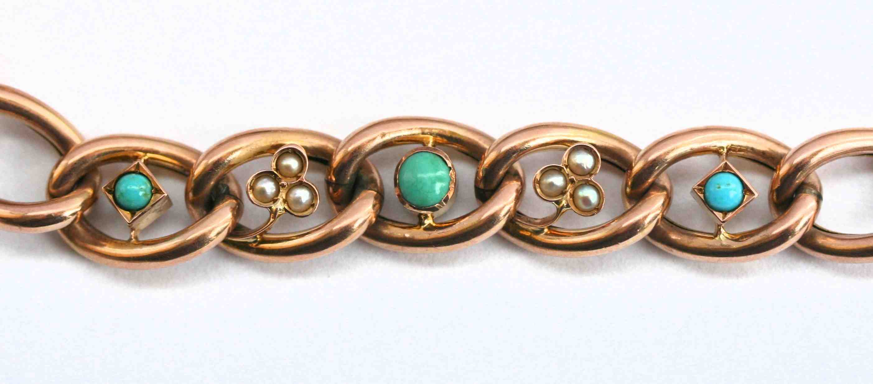 An Edwardian curb link gem set bracelet