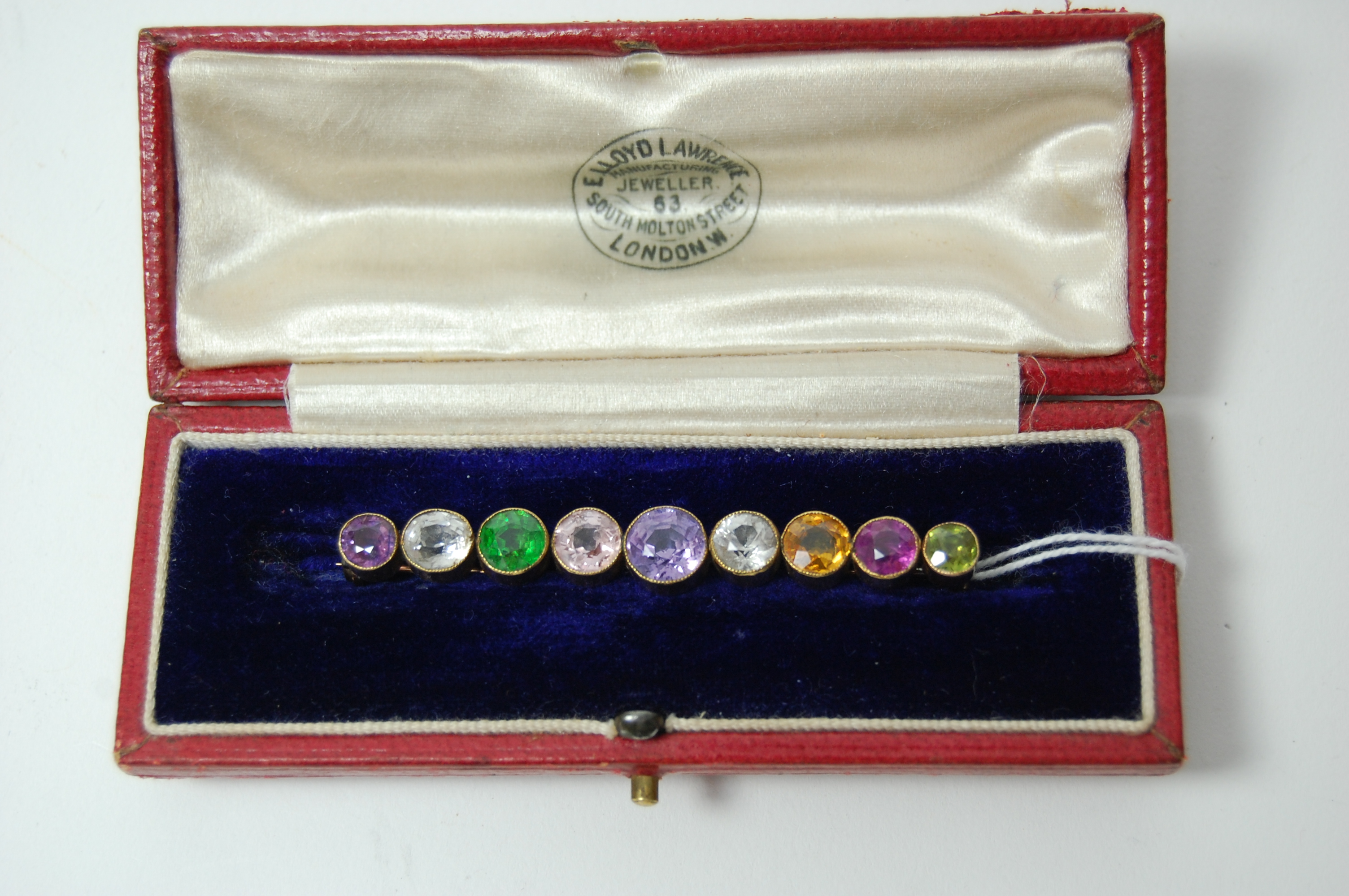 An Edwardian gold mounted multi-gem set bar brooch,