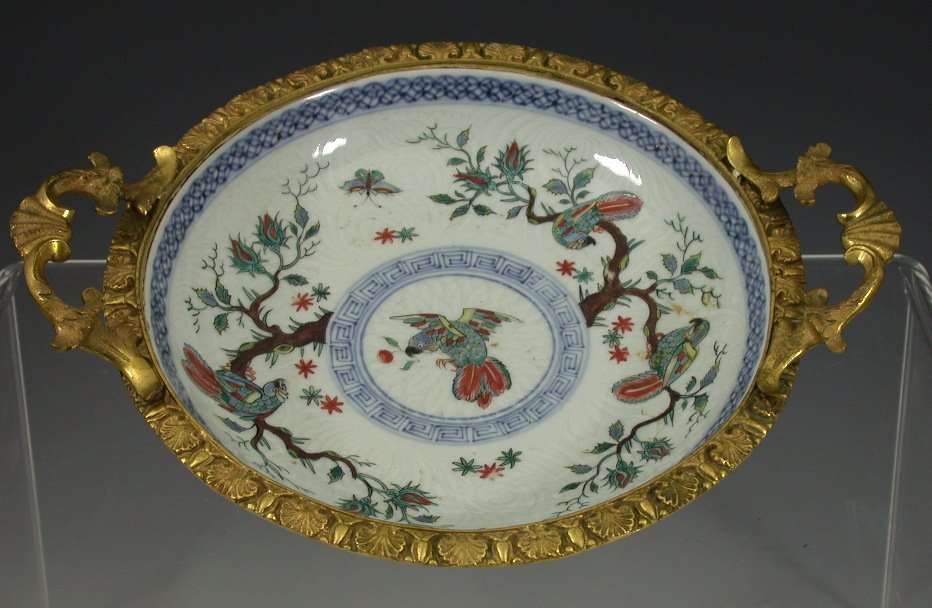 A 19th century Rococo gilt brass mounted twin handled shallow Chinese bowl