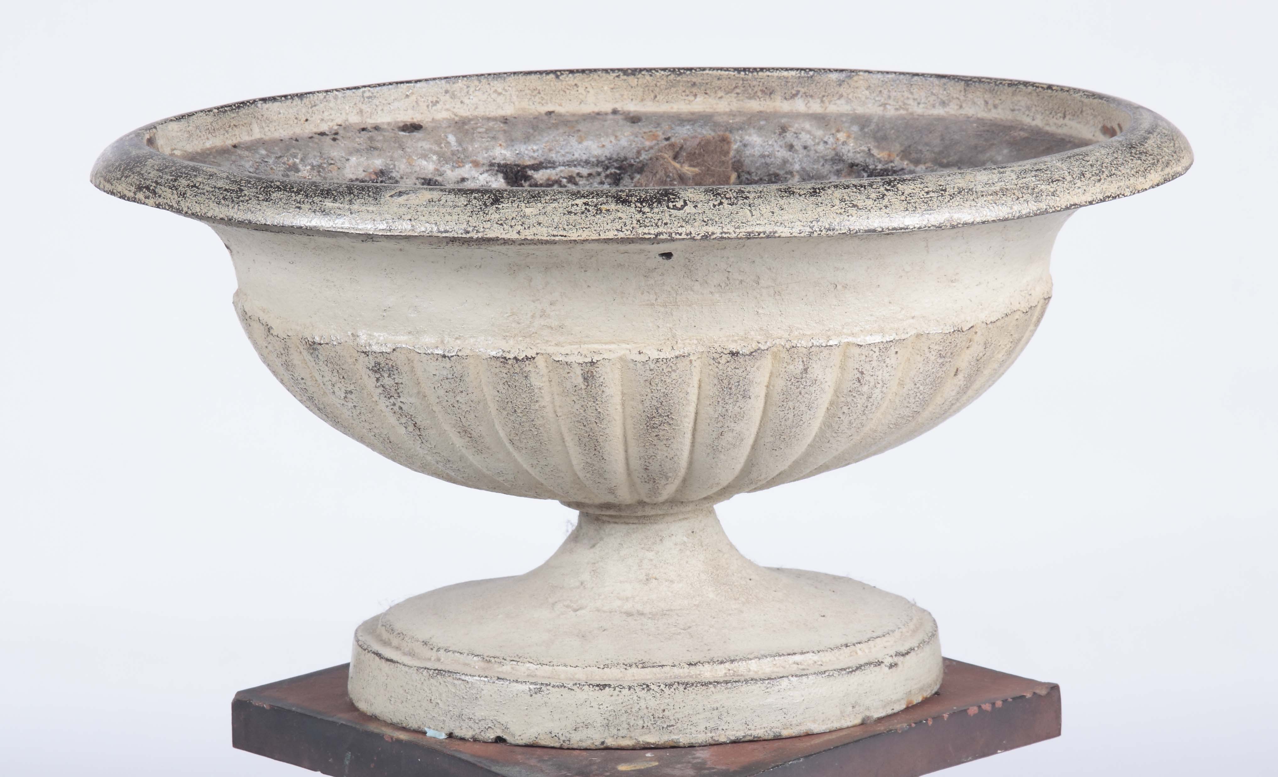 An early 20th century cast iron oval urn