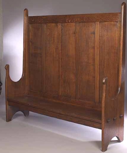 An Arts and Crafts oak settle