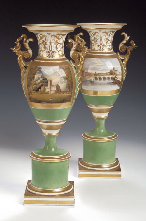 A pair of Grainger’s Worcester twin handled urns on stands