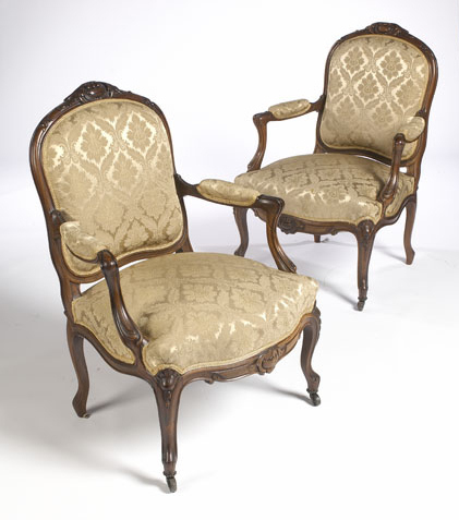 A pair of mid Victorian rosewood framed fauteuils In the Louis XV taste