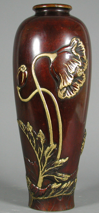 A tall Japanese relief decorated bronze vase