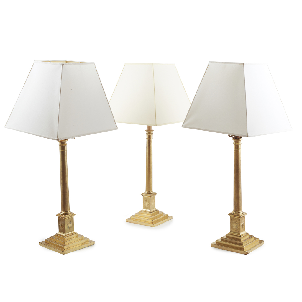 THREE GILT BRASS CANDLESTICKS