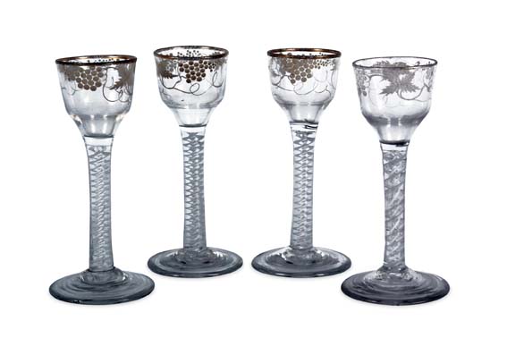 A near set of four 18th century Beilby enamelled opaque-twist wine glasses
