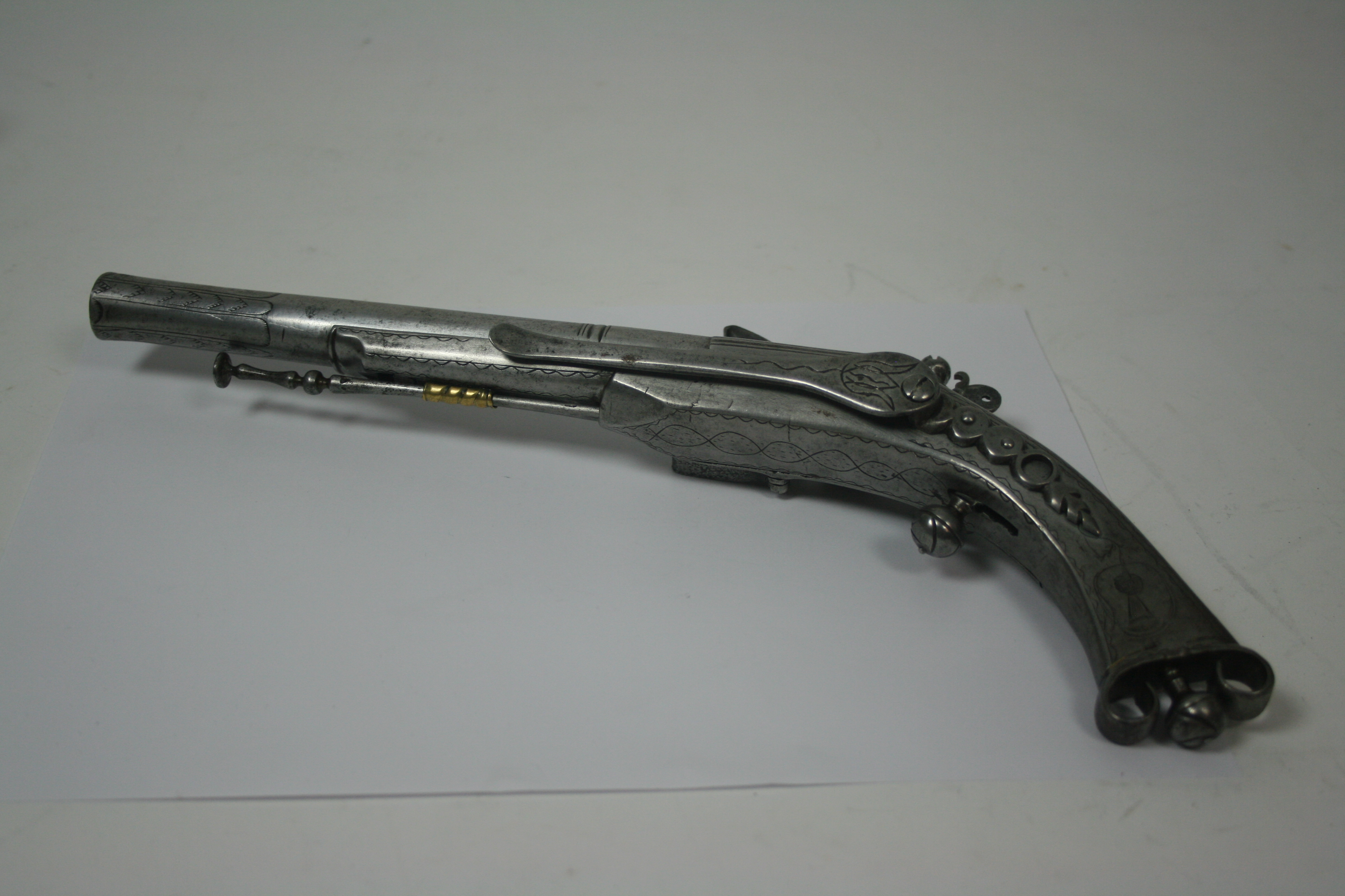 An early 18th century scroll butt flintlock steel belt pistol