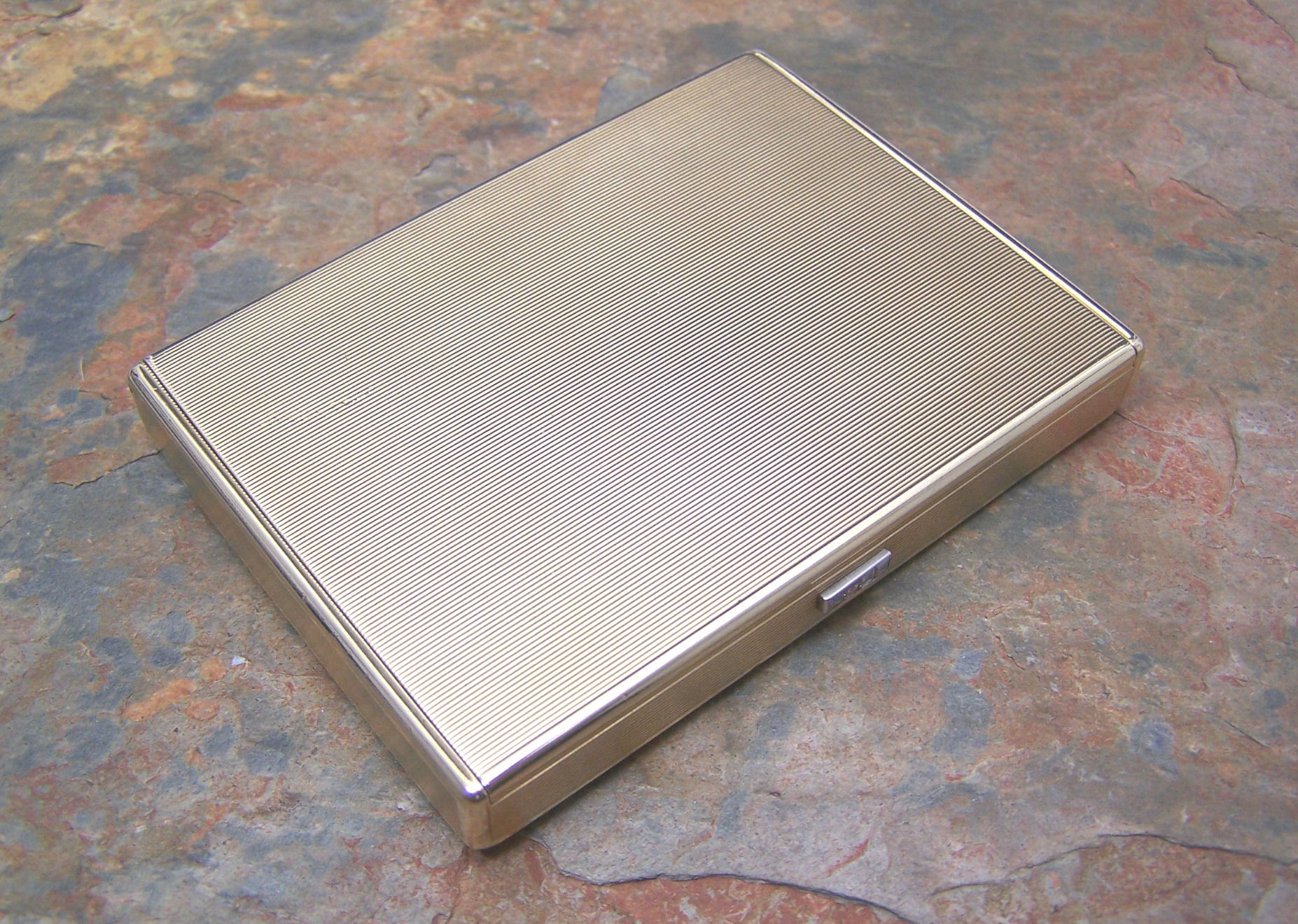 CARTIER - a 1930's 9ct gold compact,