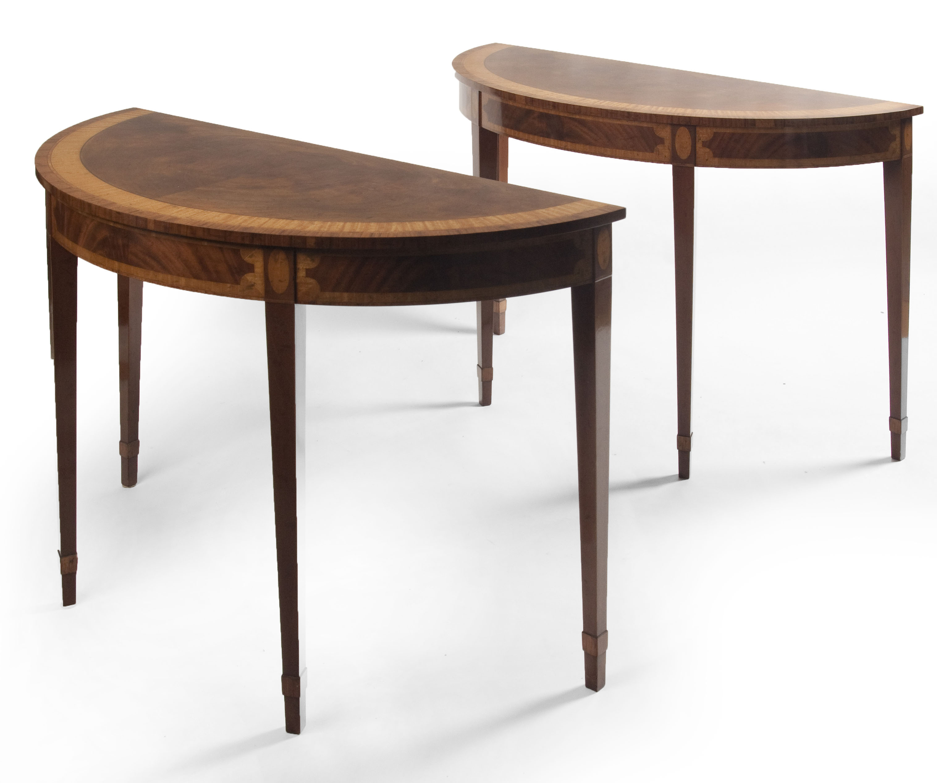 A pair of Regency style inlaid demi-lune tables