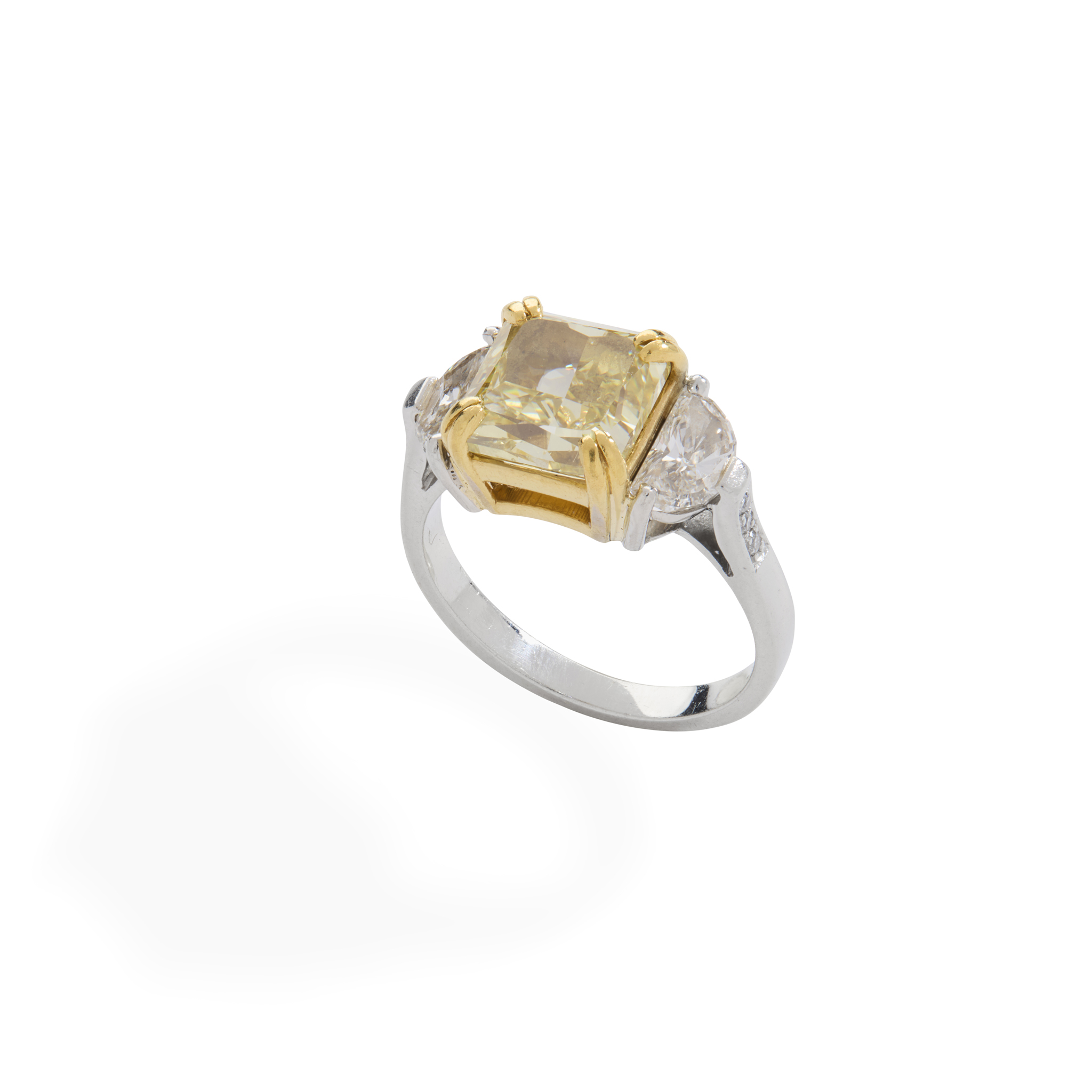 A fancy intense yellow and colourless diamond ring