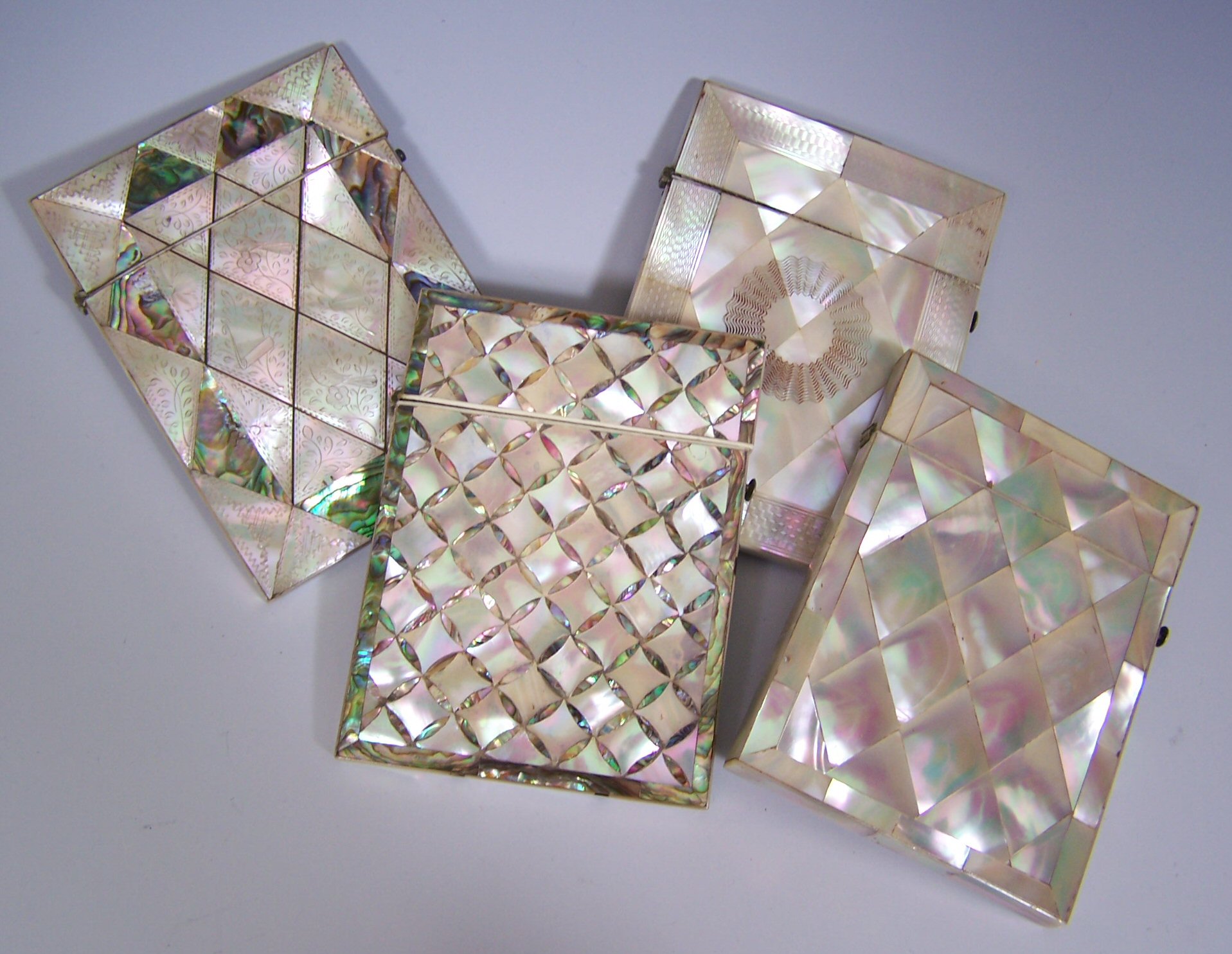 A collection of four mother of pearl card cases,