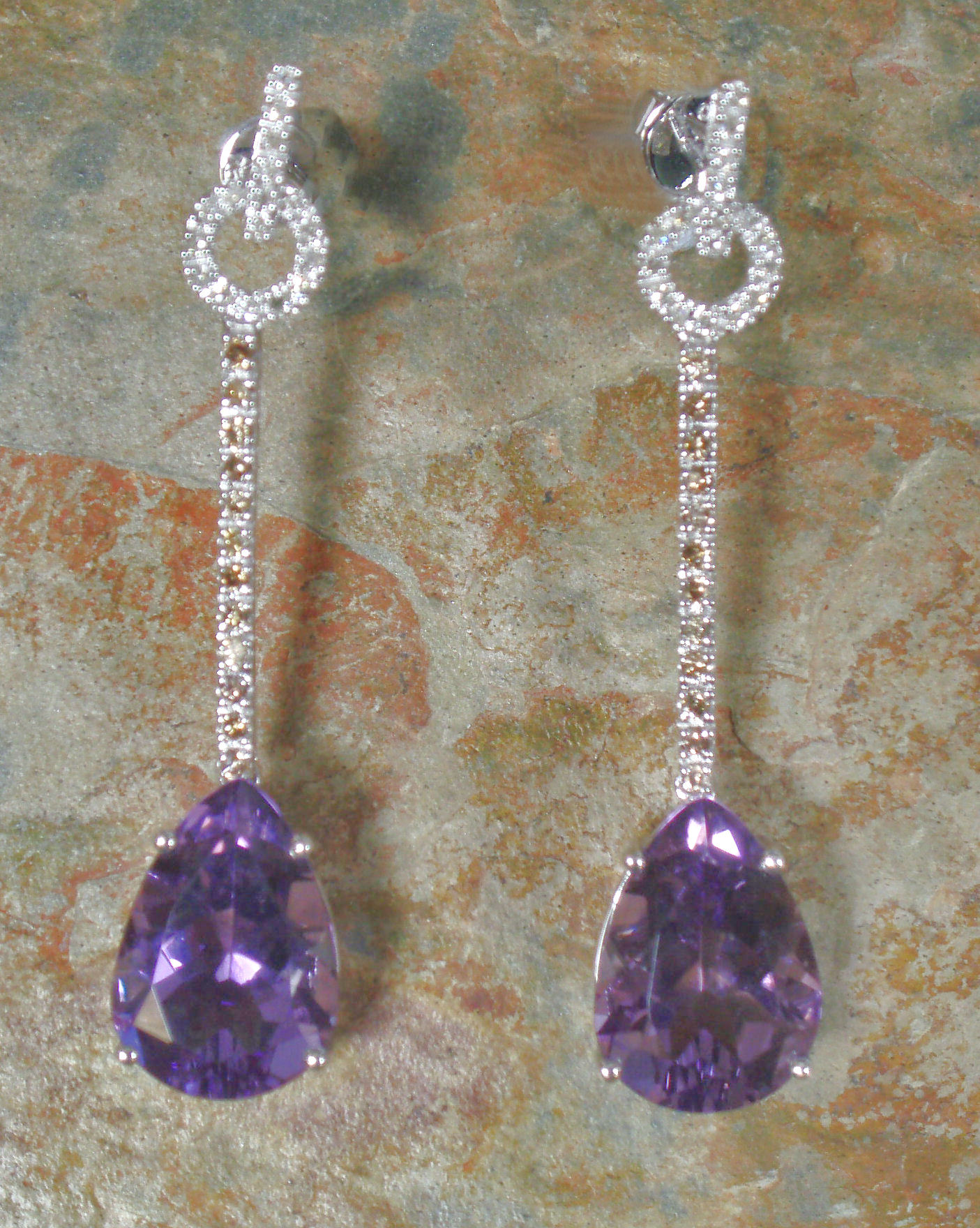 A pair of amethyst and diamond pendant earrings,