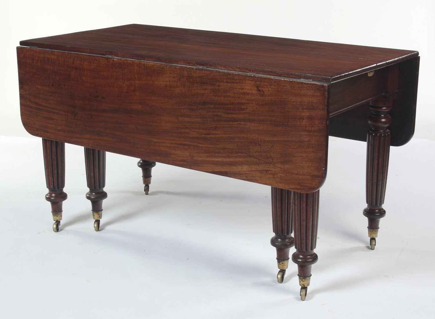 A Regency mahogany extending dining table By Gillows of Lancaster