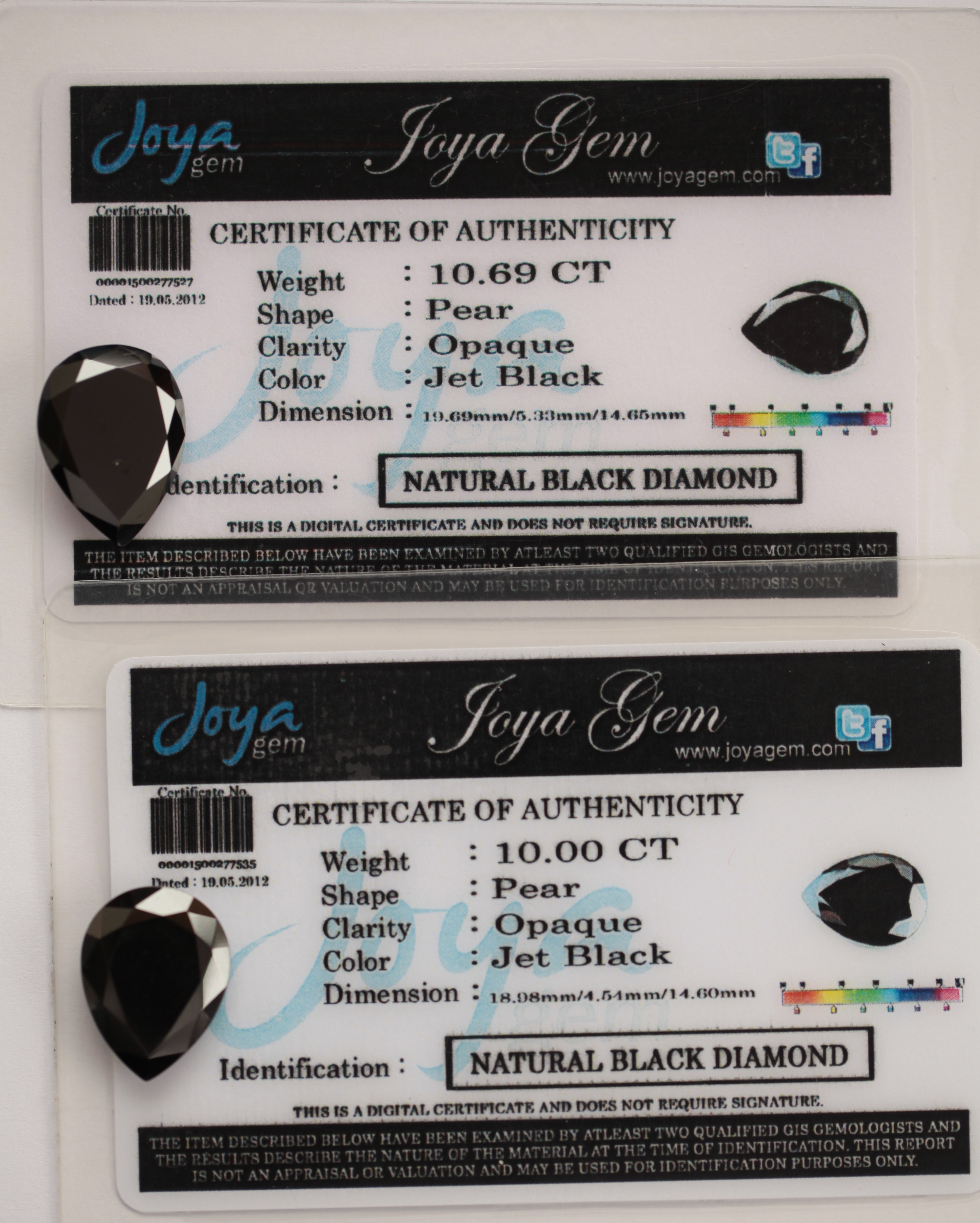 Two unmounted pear cut black diamonds