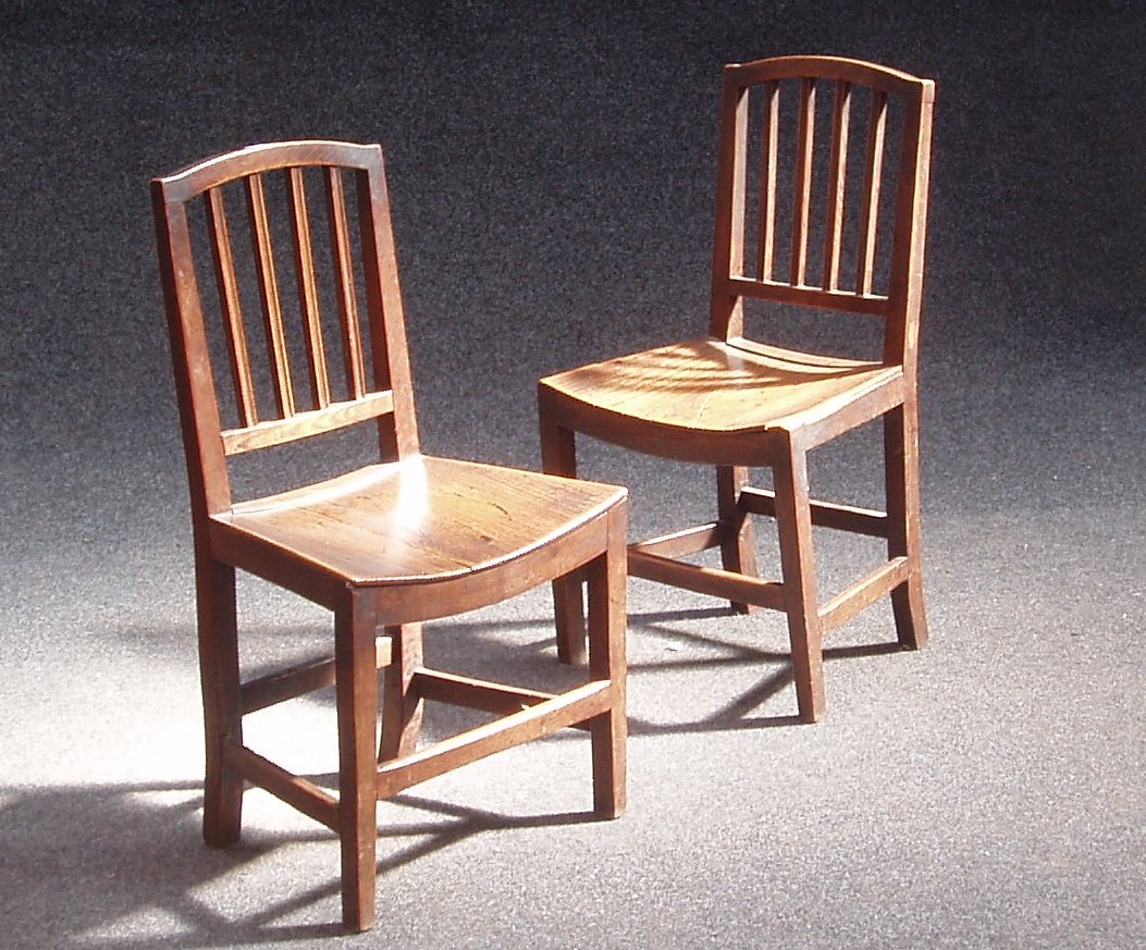 A harlequin set of six elm chairs,