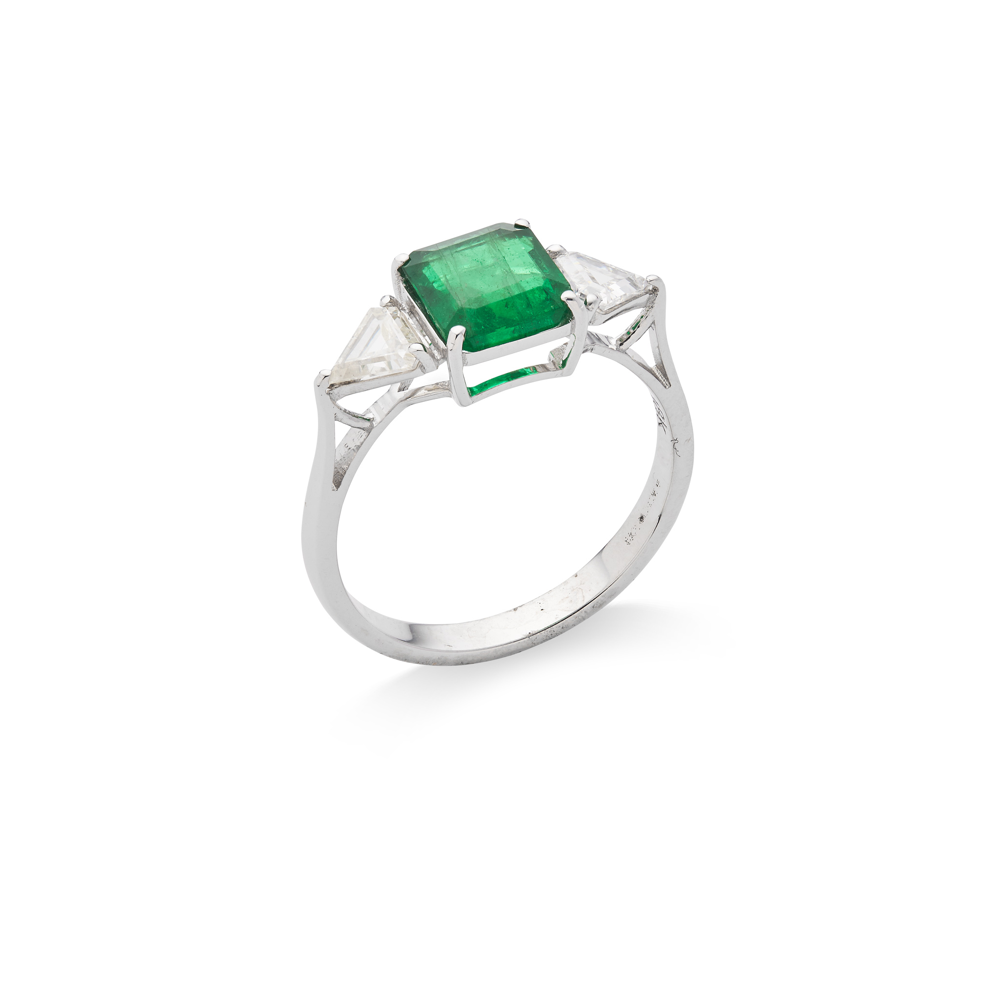 An emerald and diamond three-stone ring