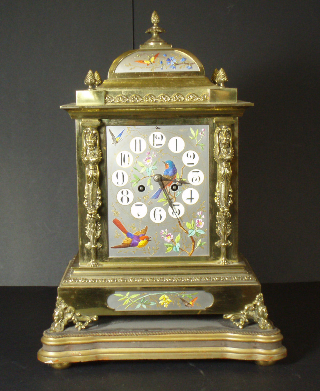 An early 20th century brass painted mantel clock