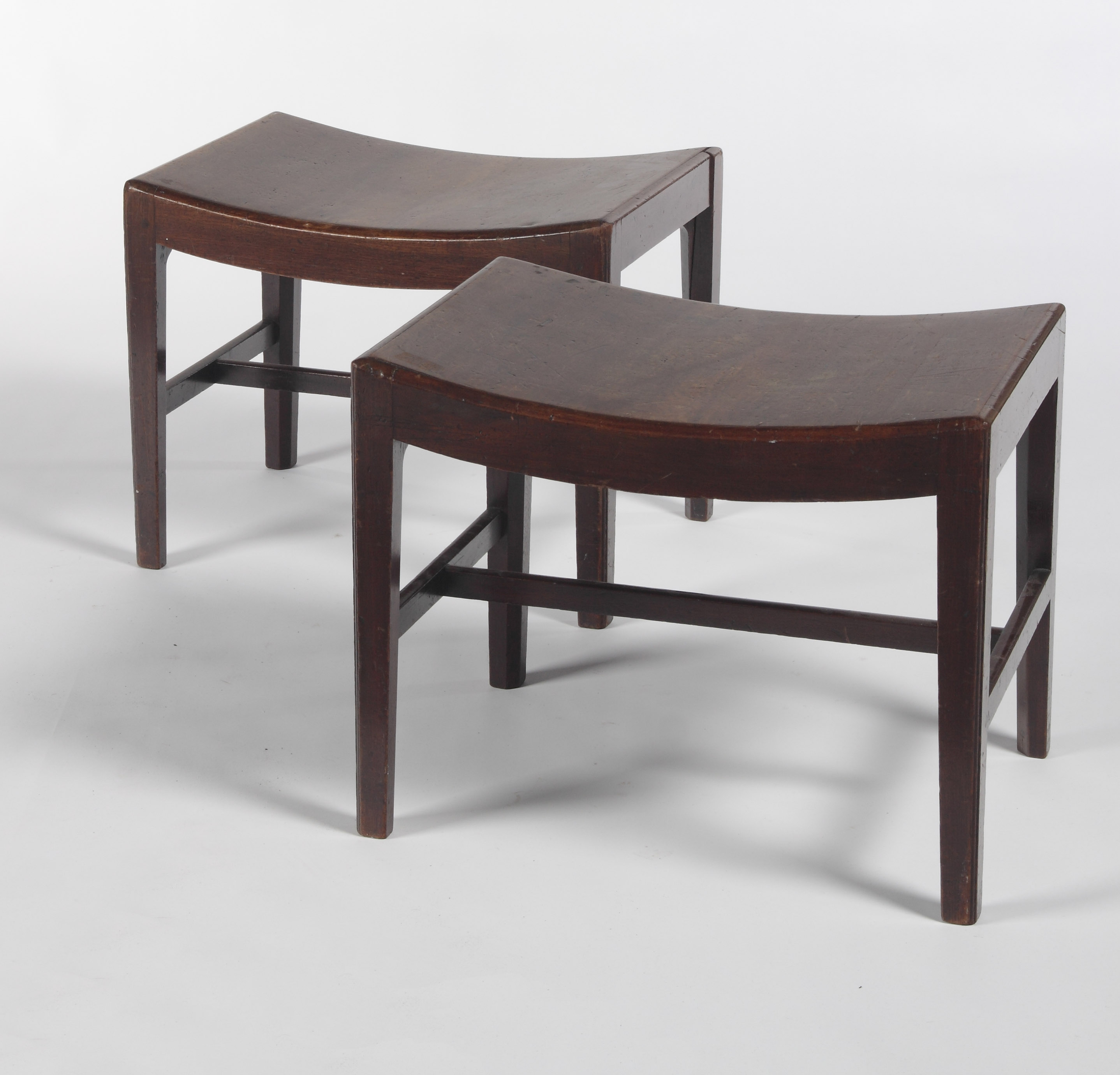 A pair of early 19th century mahogany low stools