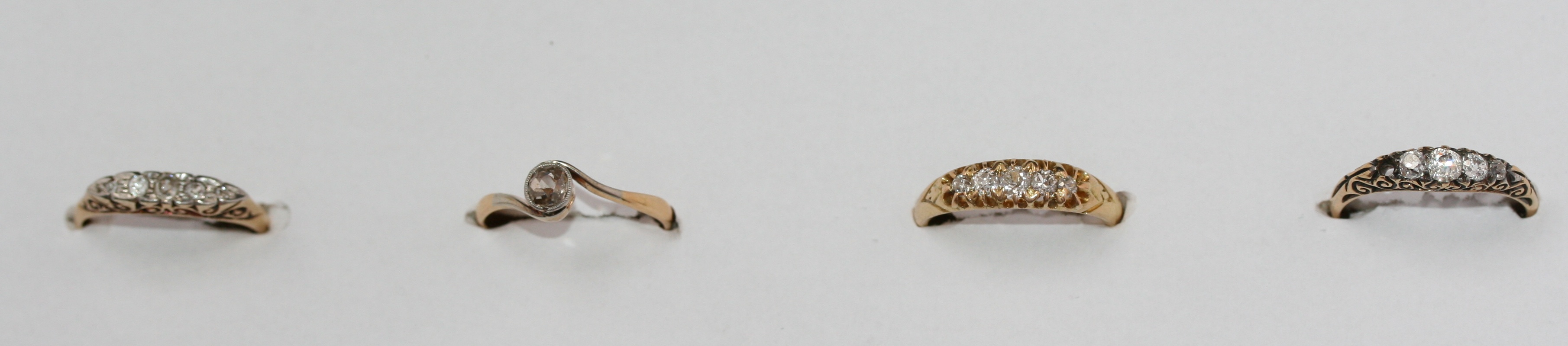 A group of four various diamond rings