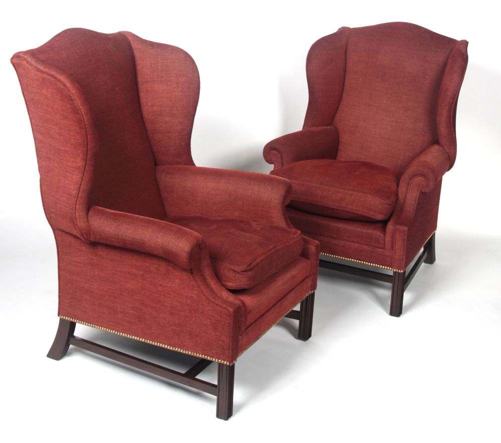 A pair of Chippendale style wingback armchairs