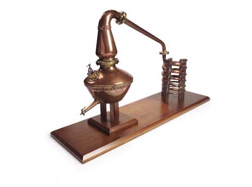 A copper and brass mounted model of a whisky still,