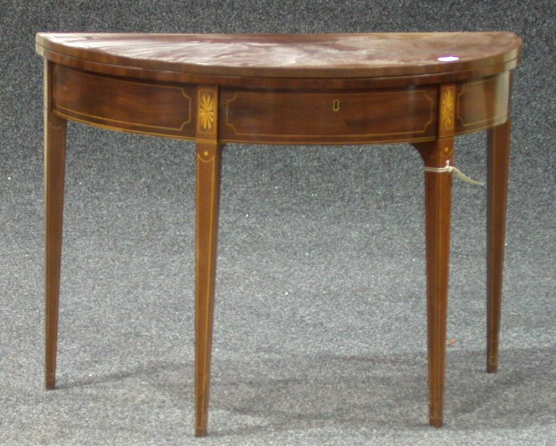 A George III mahogany foldover tea table,