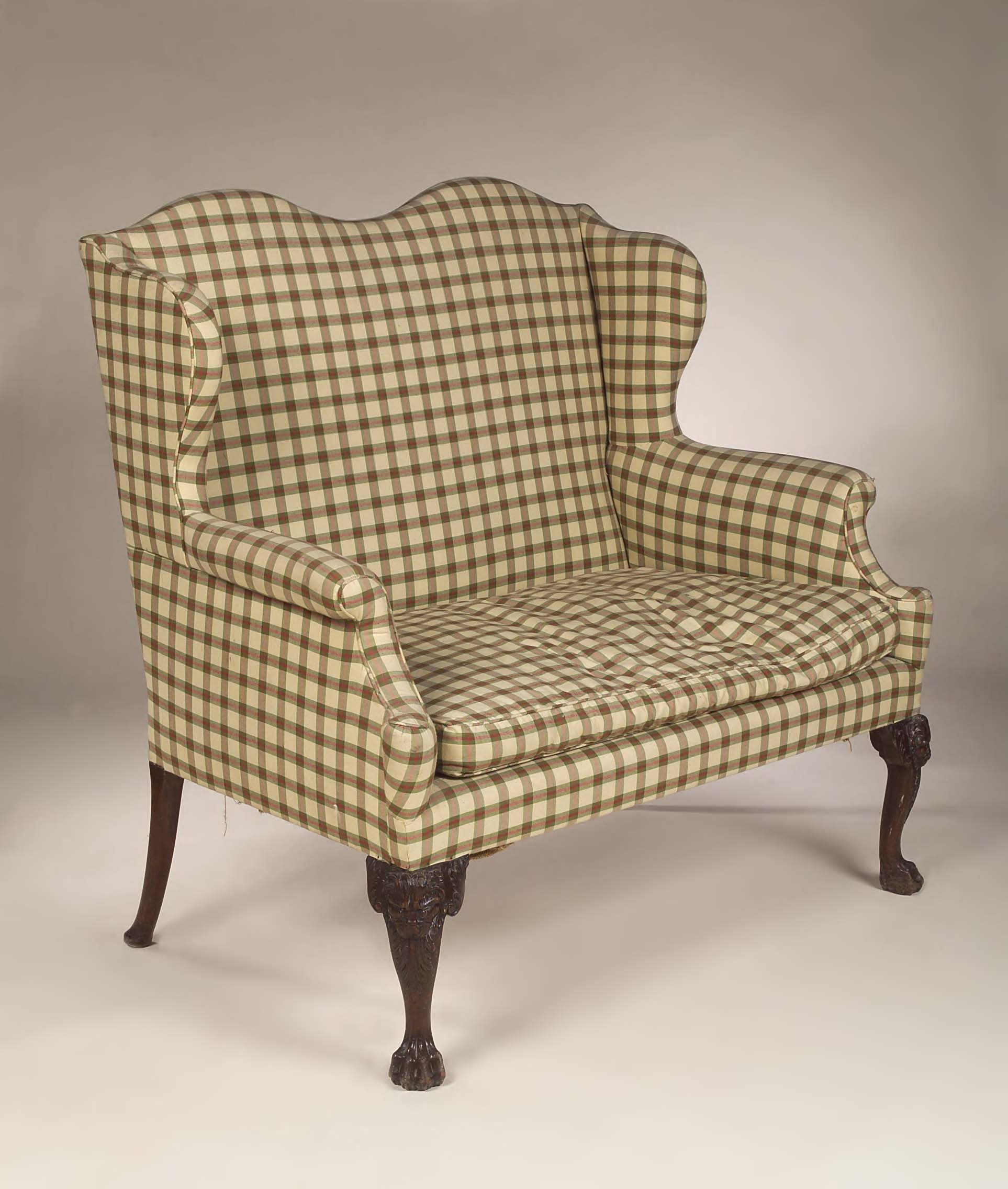 A George II mahogany two seater wing chair,