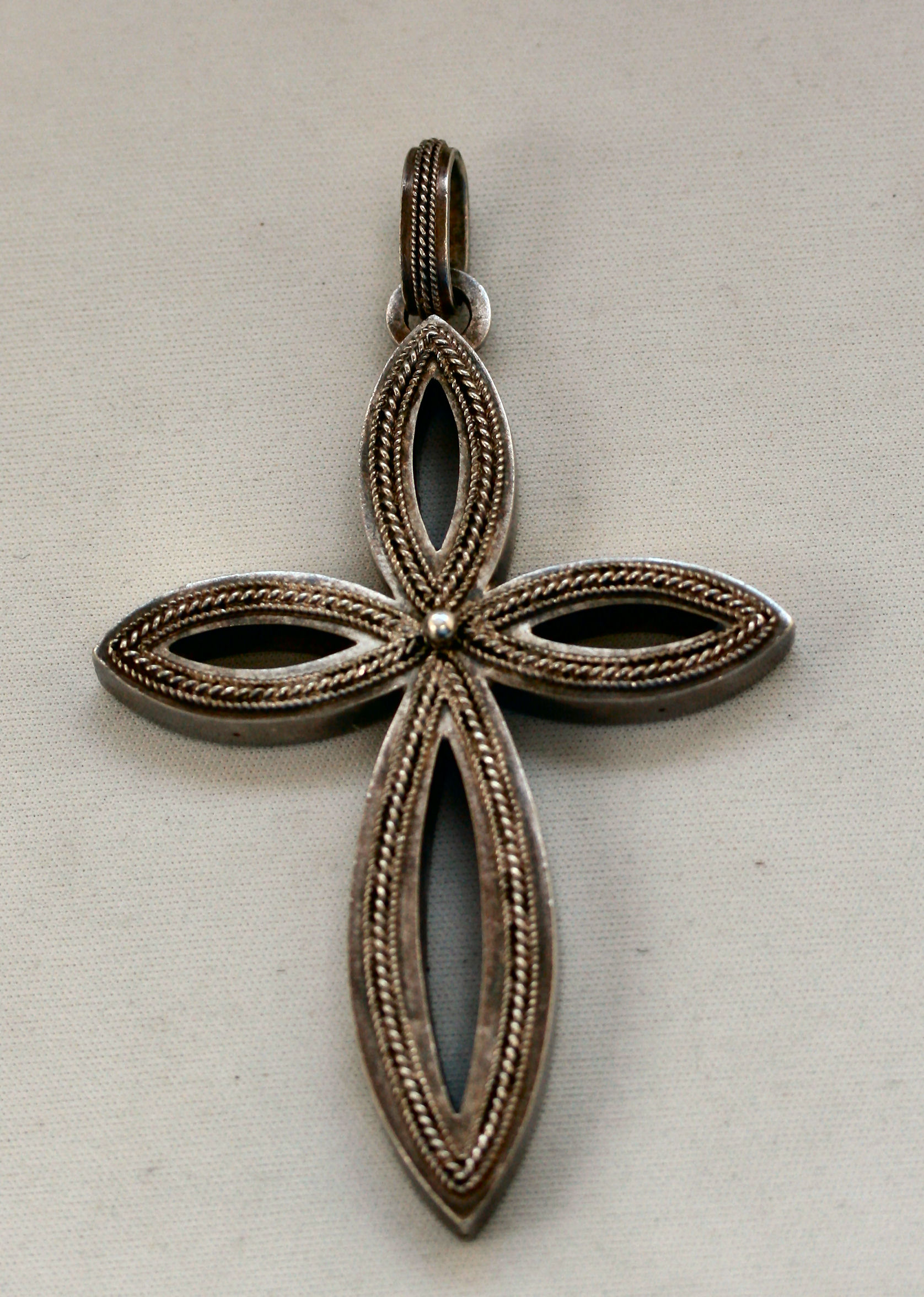 A 19th century white metal cross-form pendant,