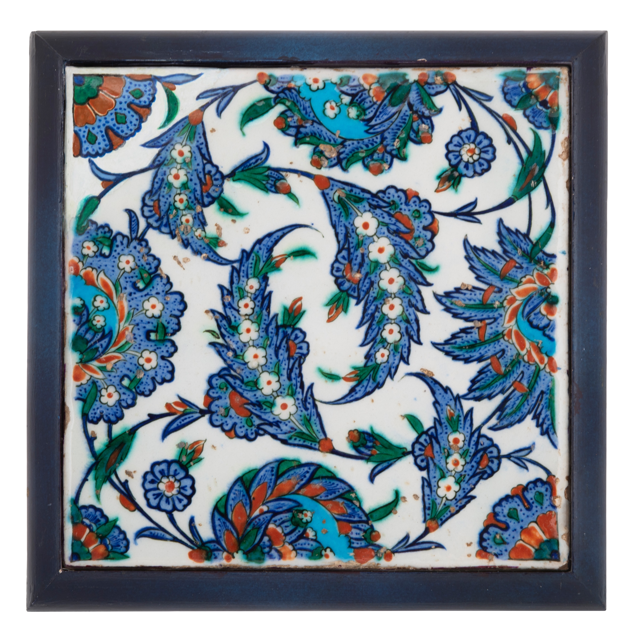 A STRIKING IZNIK POTTERY TILE WITH 'SAZ' LEAVES AND FLORAL BLOSSOMS
