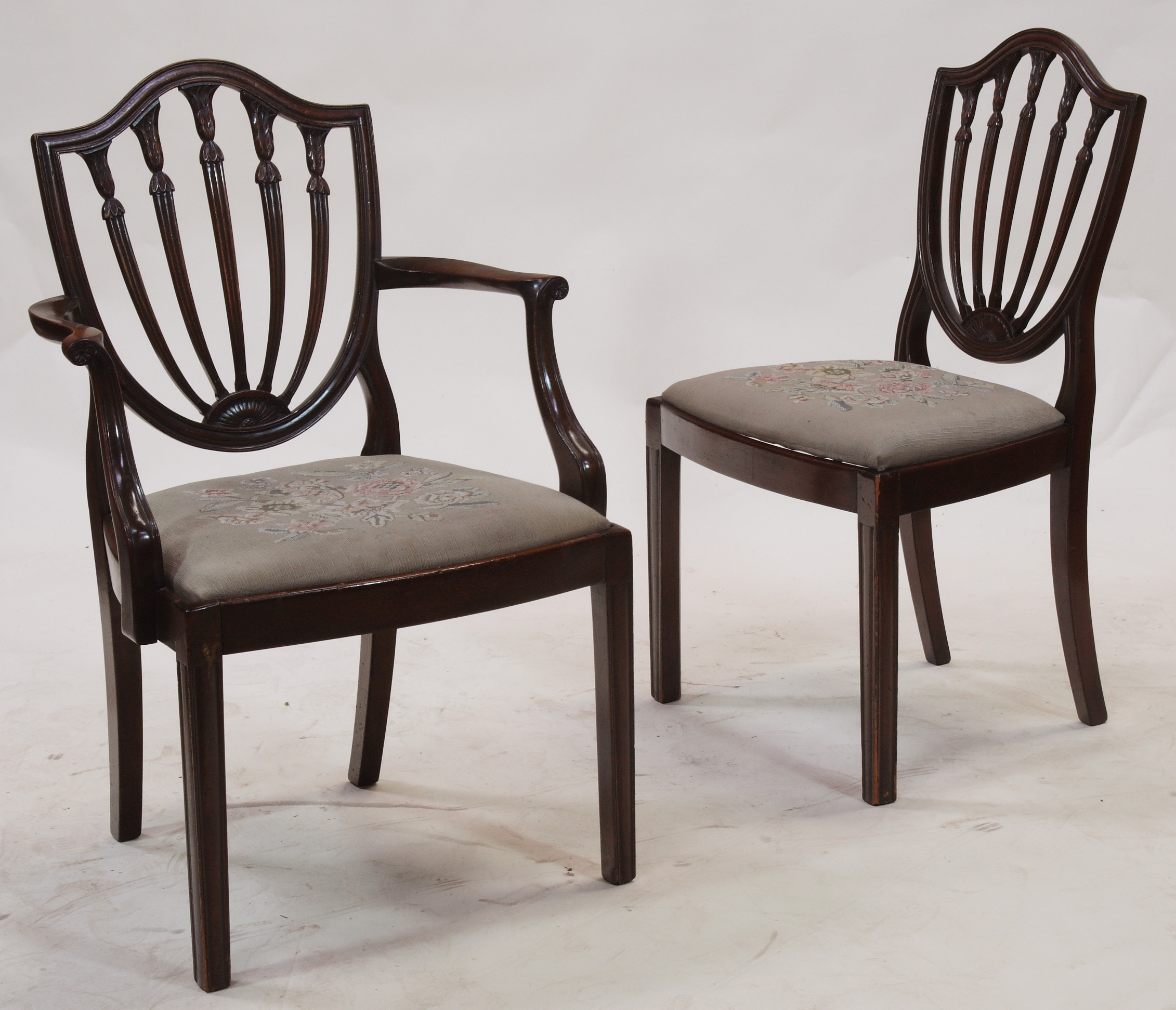 A set of sixteen mahogany Hepplewhite style shield back dining chairs