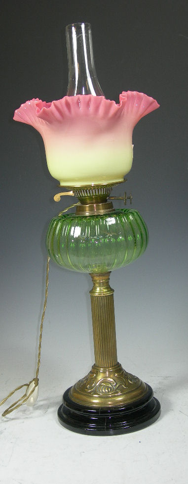 A brass and moulded glass paraffin lamp