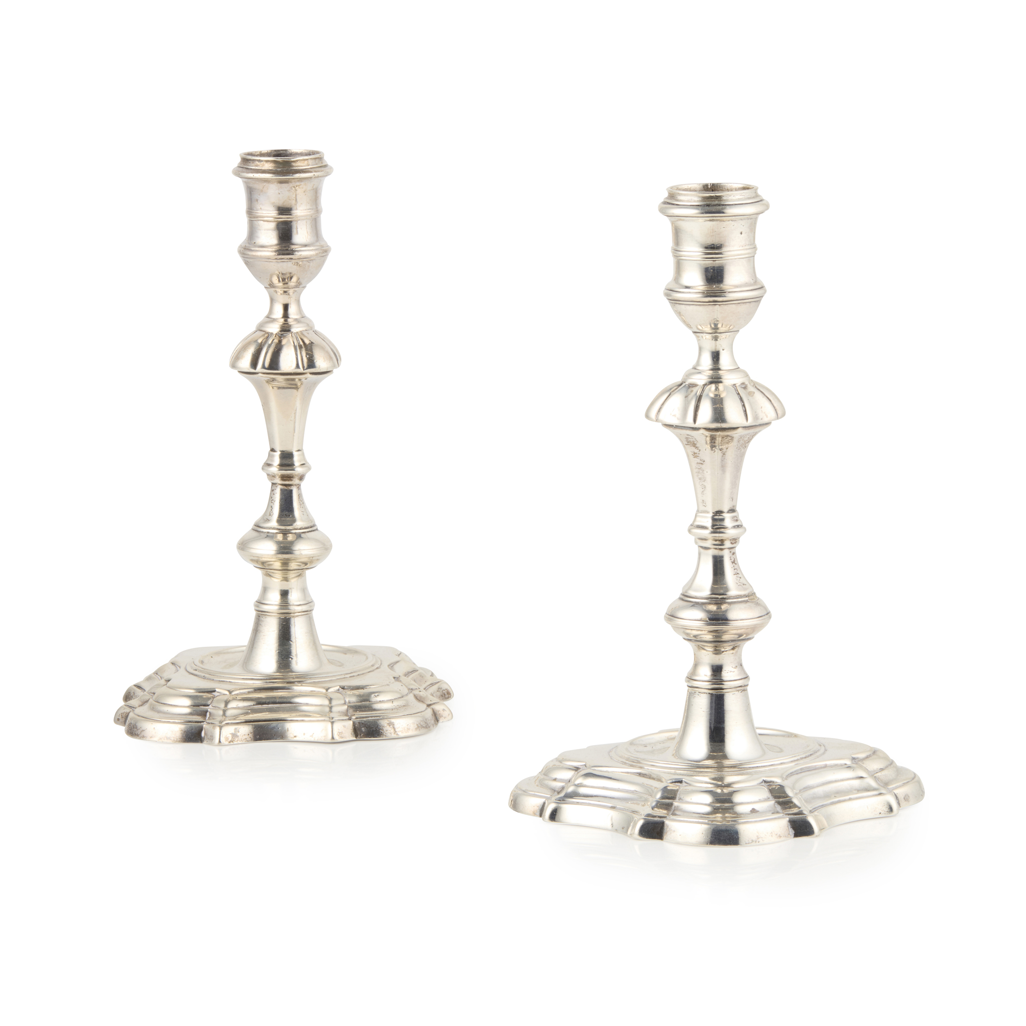 A PAIR OF CAST GEORGE II CANDLESTICKS