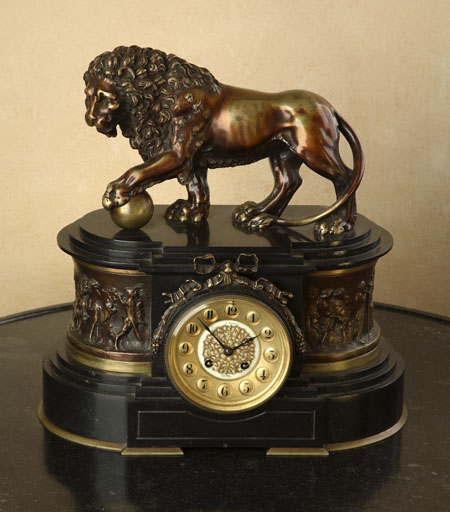 A late 19th century French patinated brass and black slate mantel clock
