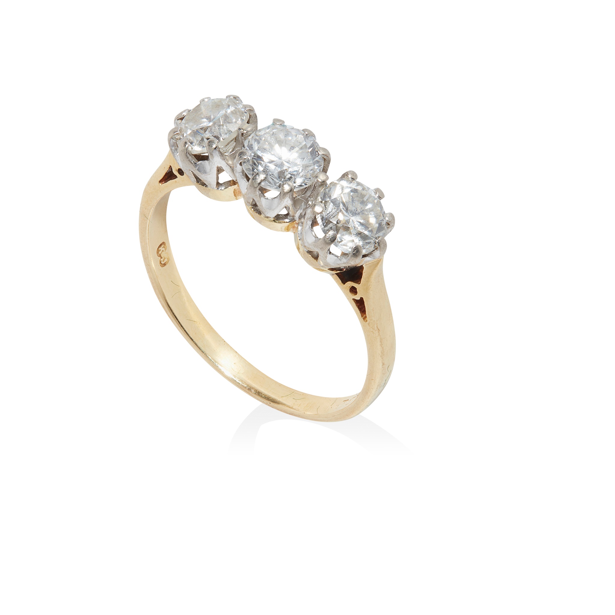 A three-stone diamond ring presented on 18ct yellow gold