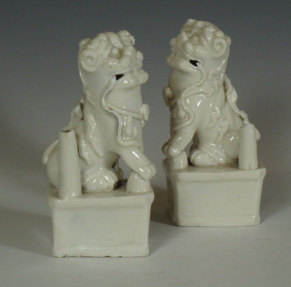 A pair of 17th century blanc de chine lion dog incense holders
