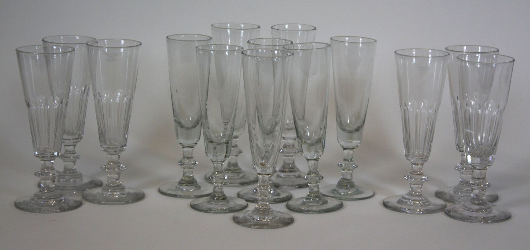 ASSEMBLED SET OF FOURTEEN GLASS CHAMPAGNE FLUTES