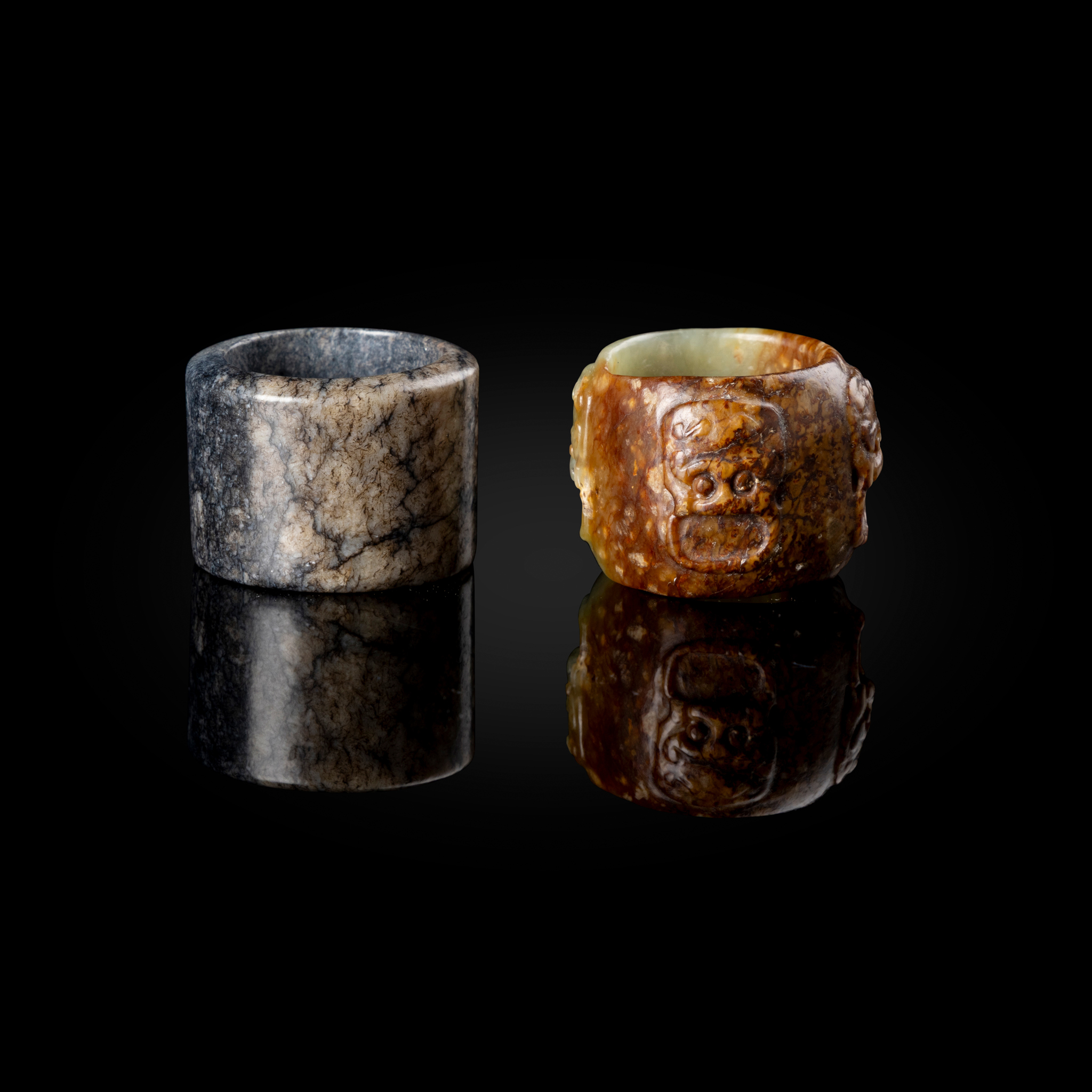 TWO CHINESE JADE THUMB RINGS