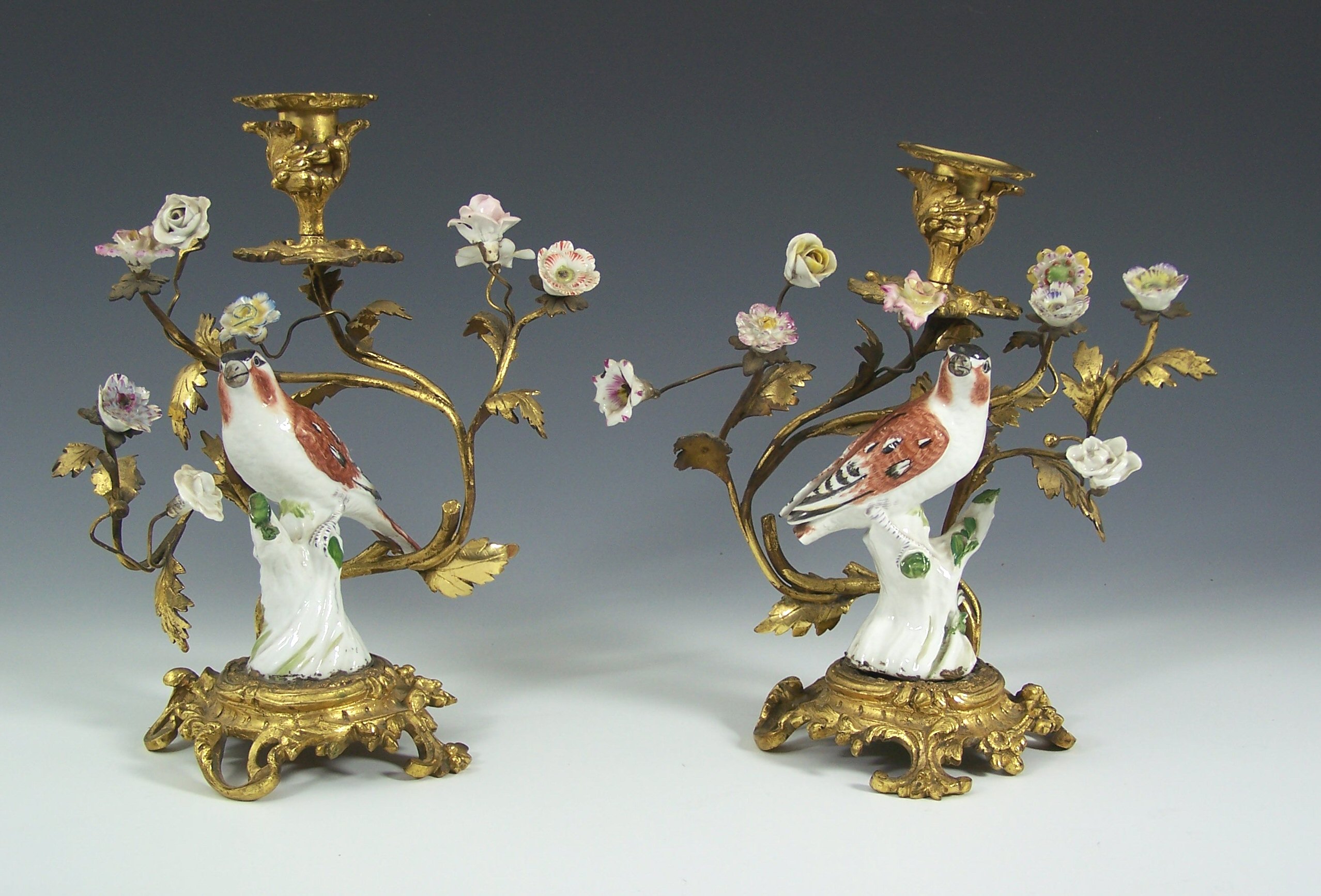 A pair of Paris giltmetal and porcelain candlesticks,