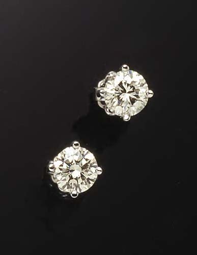 A pair of 18ct white gold mounted diamond earrings,