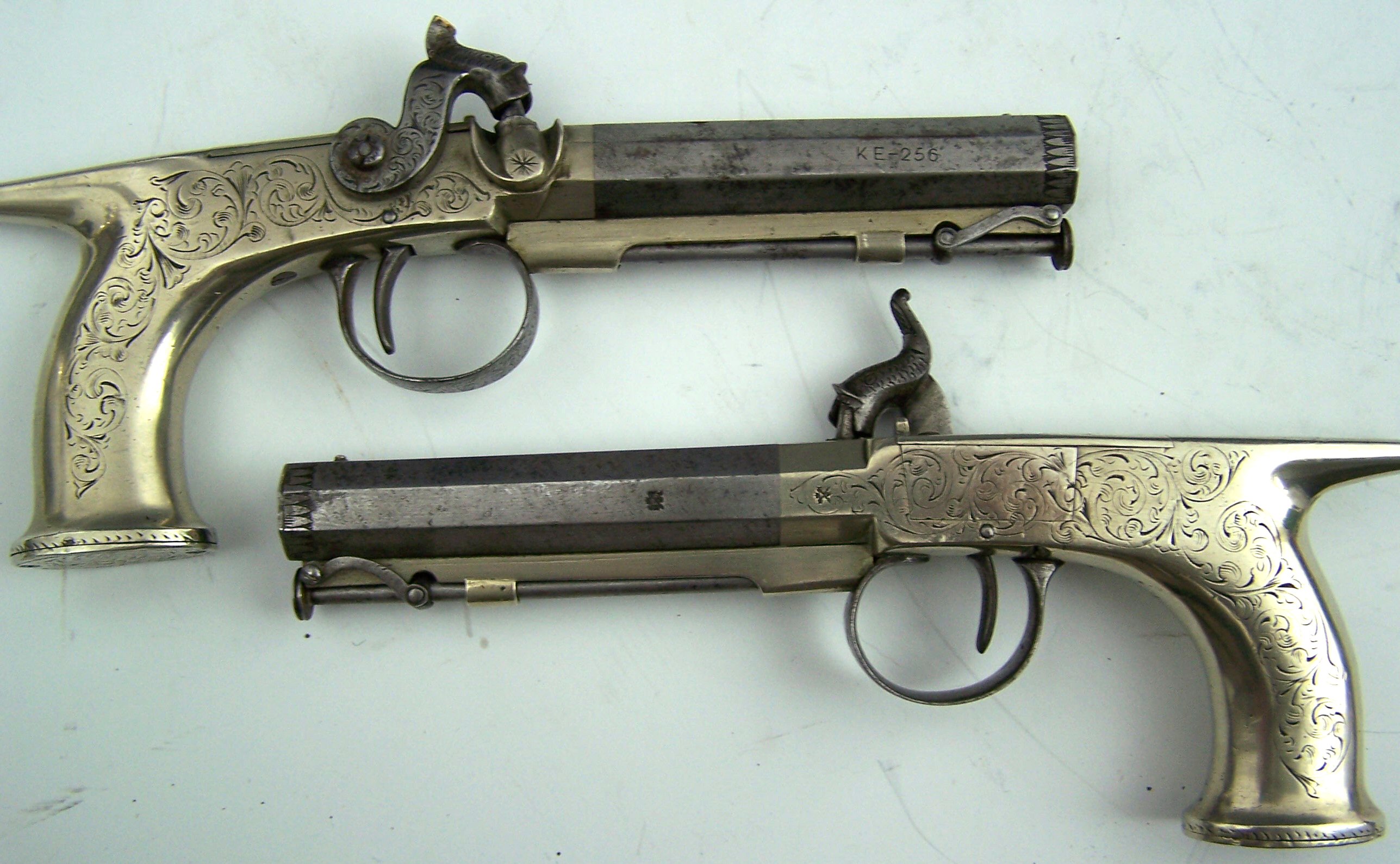 A small pair of late19th century all metal percussion pistols,