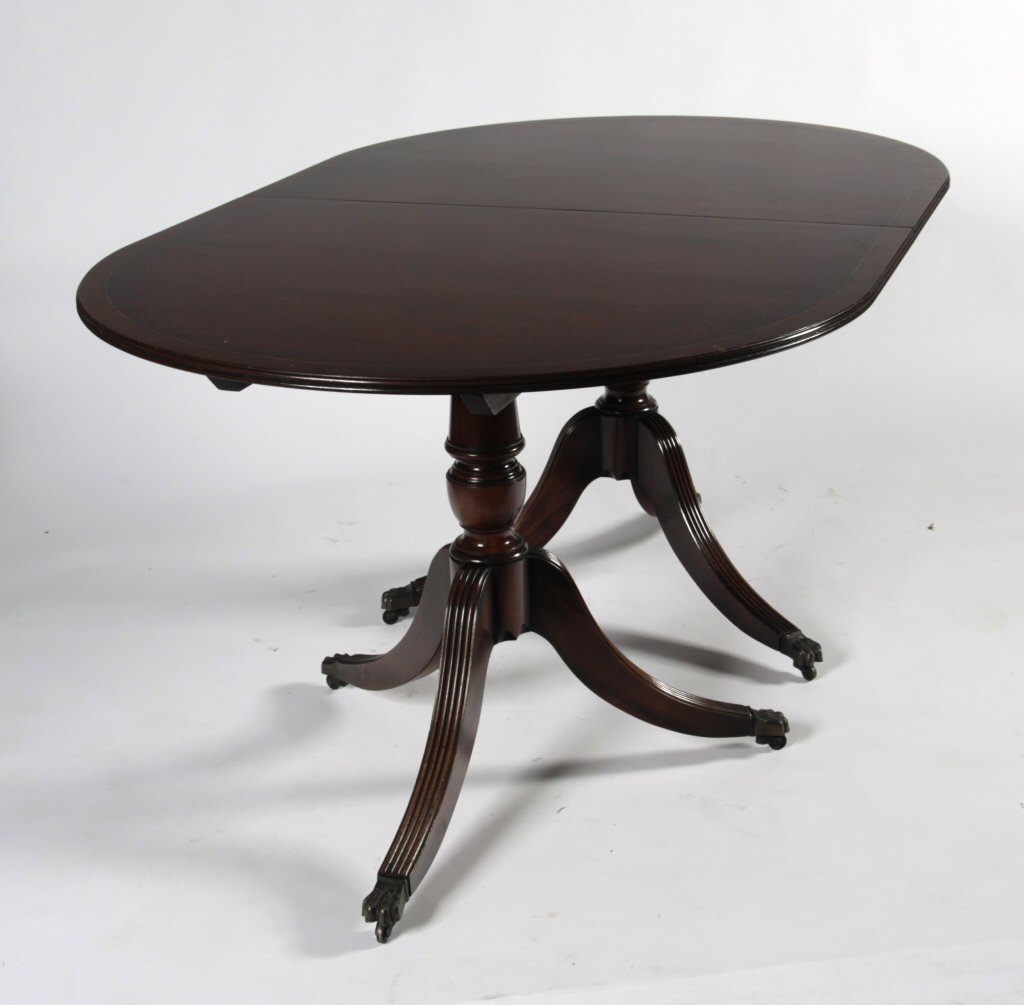 A Regency style mahogany twin pedestal dining table