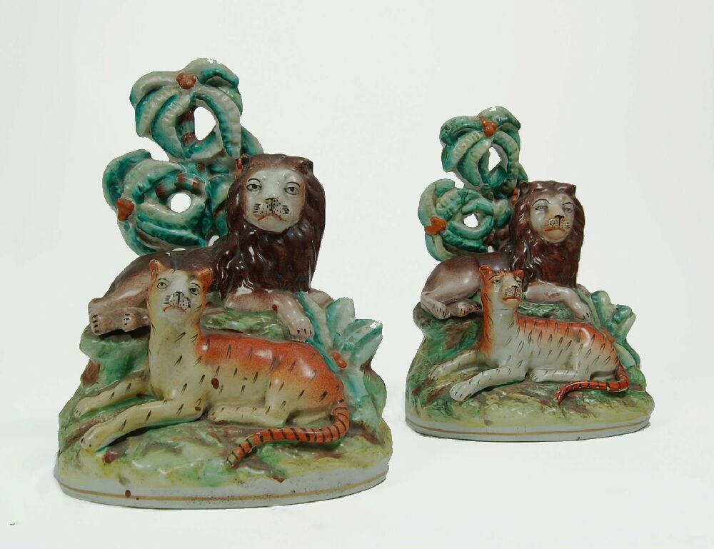 A pair of rare 19th century Staffordshire lion and tiger figure groups