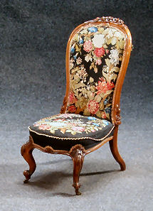 A Victorian walnut nursing chair