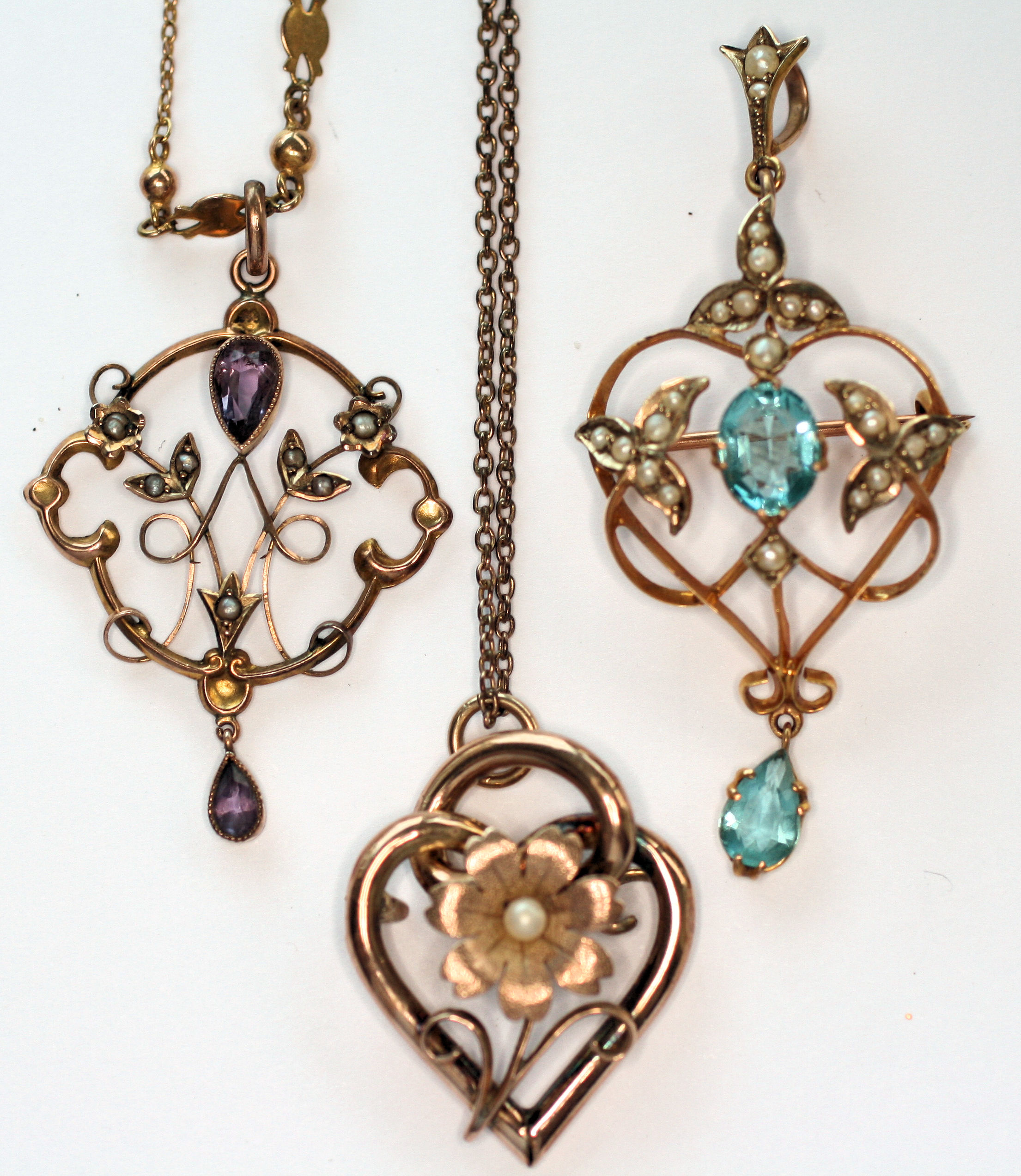 A group of three Edwardian gem set pendants