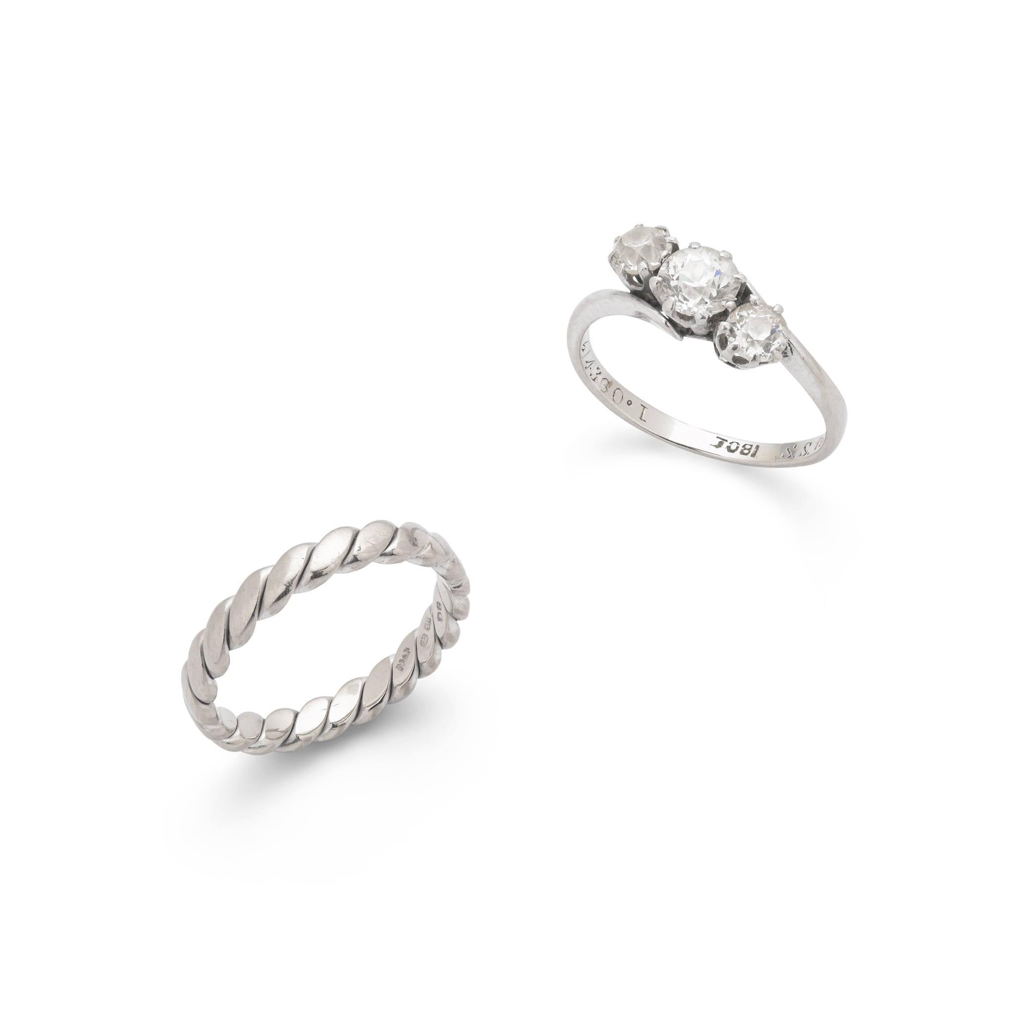 A diamond three-stone ring and wedding band