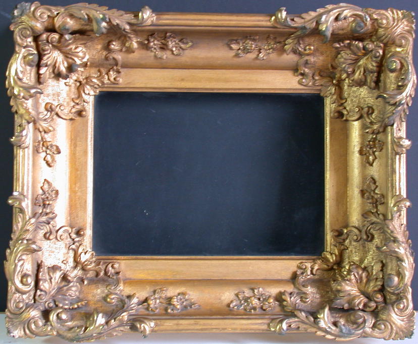 A HEAVILY DECORATED 19TH CENTURY GILT FRAME
