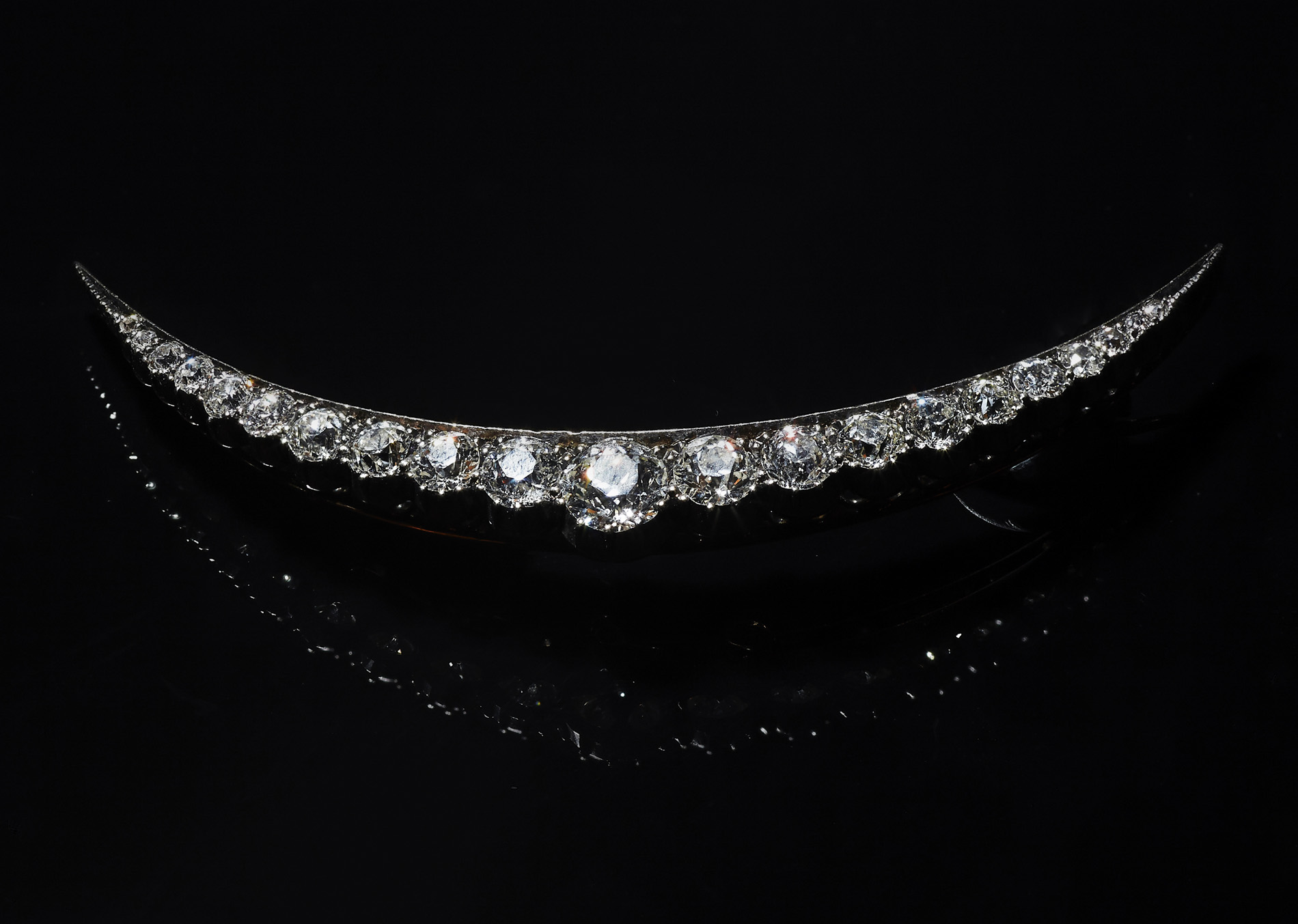 An early 20th century diamond set crescent brooch