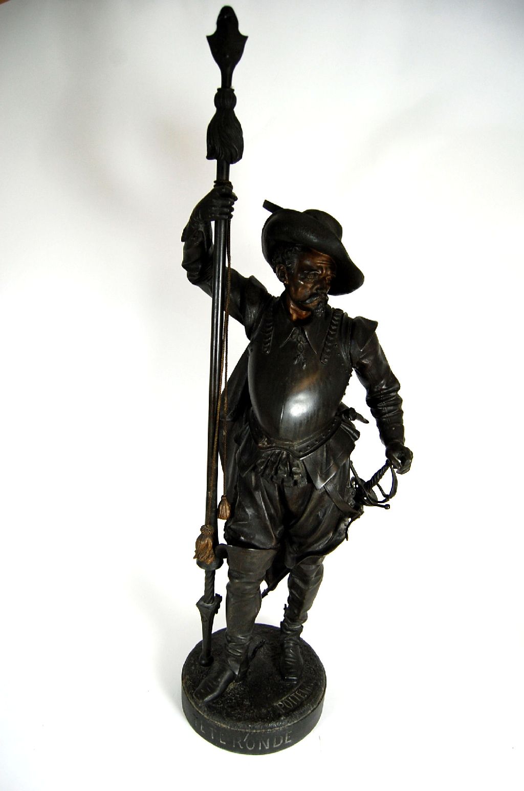 A patinated metal figure of a standing 17th century soldier